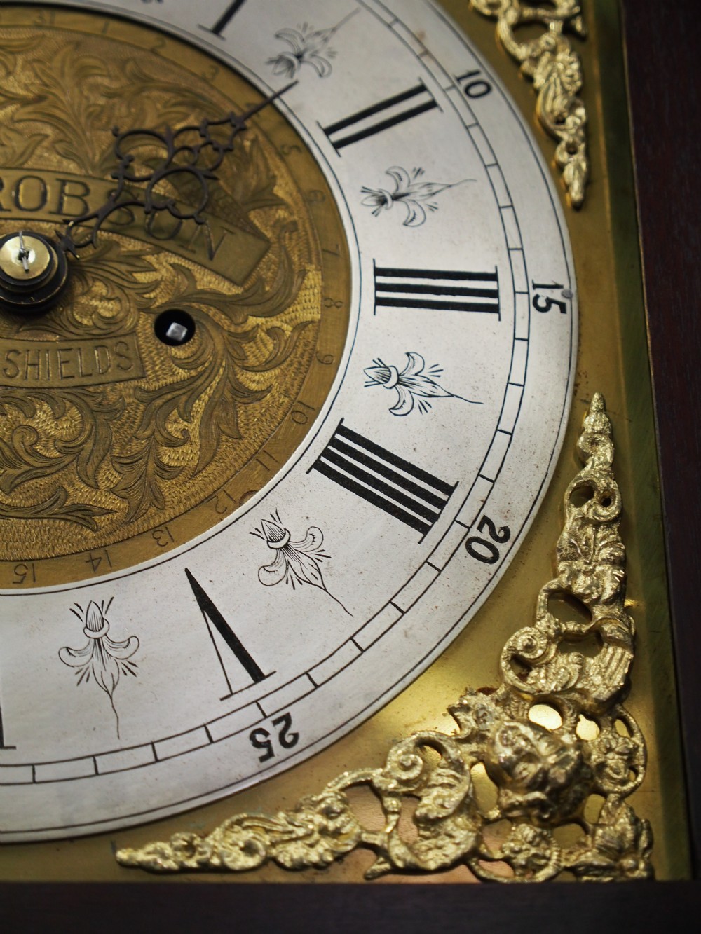 A tall Victorian mahogany longcase clock featuring a swan-neck pediment with fretwork, marquetry inlay, and a brass dial face. View XVI