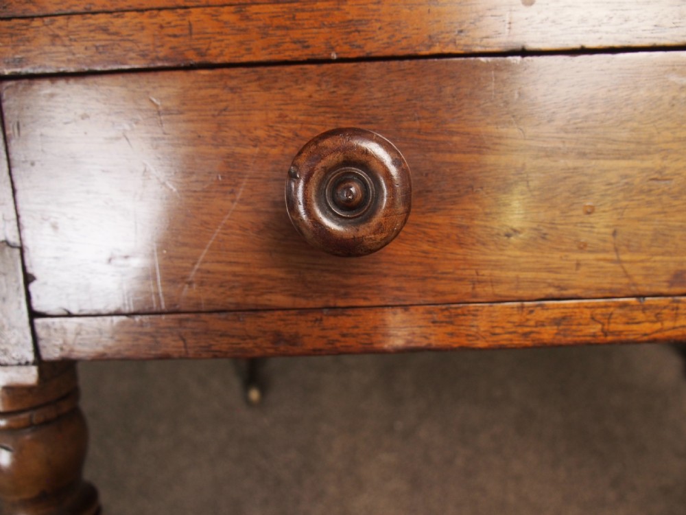 A George IV mahogany Canterbury featuring four slatted compartments with turned spindles, a single base drawer with turned wooden knobs, and turned legs ending in brass castors. View XIV