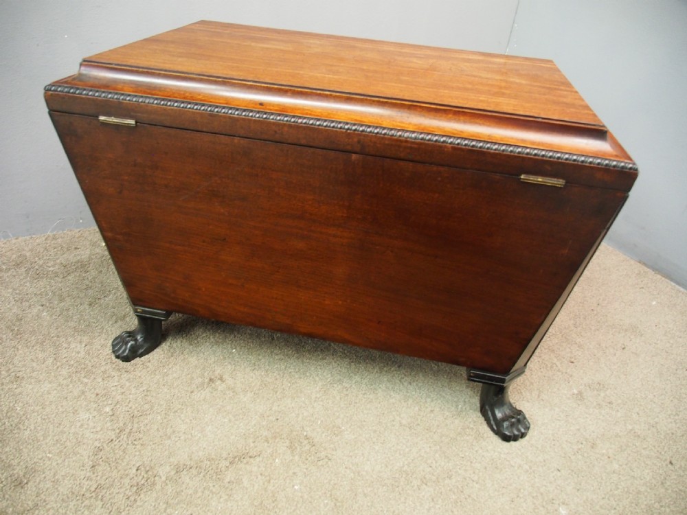A Scottish Regency mahogany sarcophagus-shaped wine cooler featuring carved claw feet, gadrooned moulding, and side brass lion-mask drop ring handles. View VIII