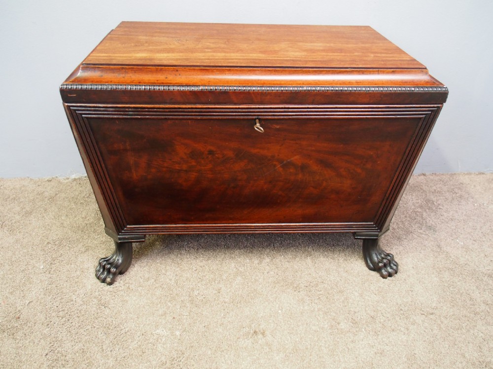 A Scottish Regency mahogany sarcophagus-shaped wine cooler featuring carved claw feet, gadrooned moulding, and side brass lion-mask drop ring handles. View XIII