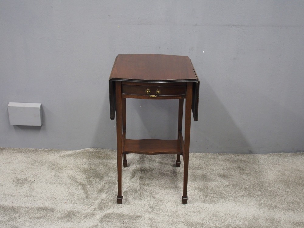 A Georgian style dark mahogany Pembroke table featuring two hinged drop leaves, a single frieze drawer with a brass pull handle, a lower undertier, and four straight legs. View II