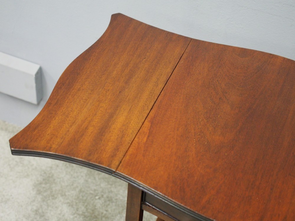 A Georgian style dark mahogany Pembroke table featuring two hinged drop leaves, a single frieze drawer with a brass pull handle, a lower undertier, and four straight legs. View V