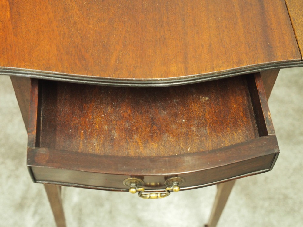 A Georgian style dark mahogany Pembroke table featuring two hinged drop leaves, a single frieze drawer with a brass pull handle, a lower undertier, and four straight legs. View VIII