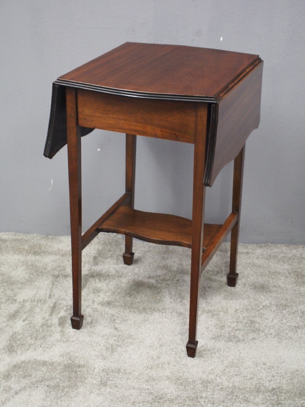 A Georgian style dark mahogany Pembroke table featuring two hinged drop leaves, a single frieze drawer with a brass pull handle, a lower undertier, and four straight legs. View IX