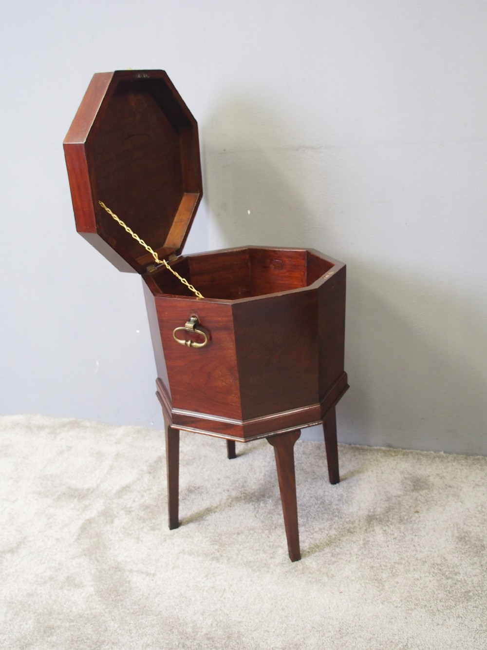 An eighteenth century octagonal mahogany wine cooler featuring brass drop handles, geometric edge inlay, and tapered legs. View II