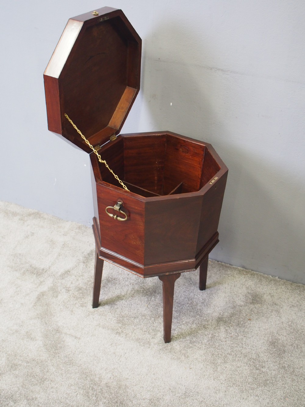 An eighteenth century octagonal mahogany wine cooler featuring brass drop handles, geometric edge inlay, and tapered legs. View III