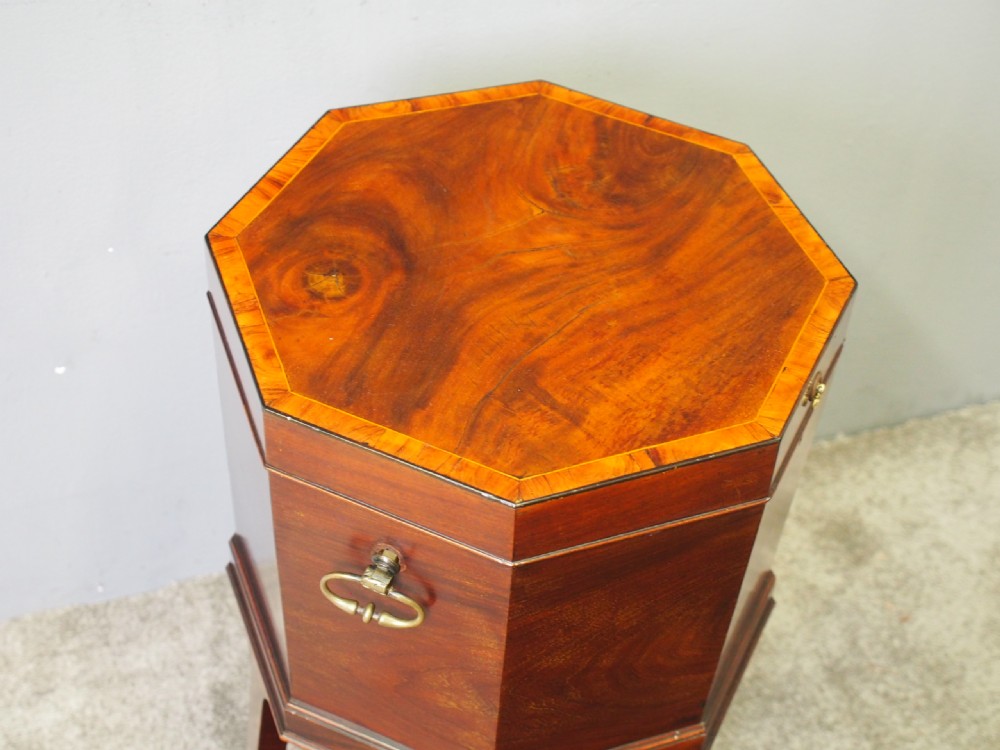 An eighteenth century octagonal mahogany wine cooler featuring brass drop handles, geometric edge inlay, and tapered legs. View IV