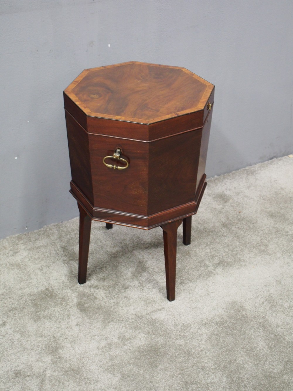 An eighteenth century octagonal mahogany wine cooler featuring brass drop handles, geometric edge inlay, and tapered legs. View VI