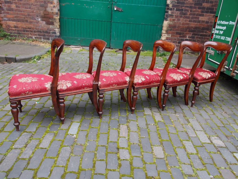 A set of six Victorian mahogany balloon back dining chairs with red patterned upholstered seats and turned front legs. View IV