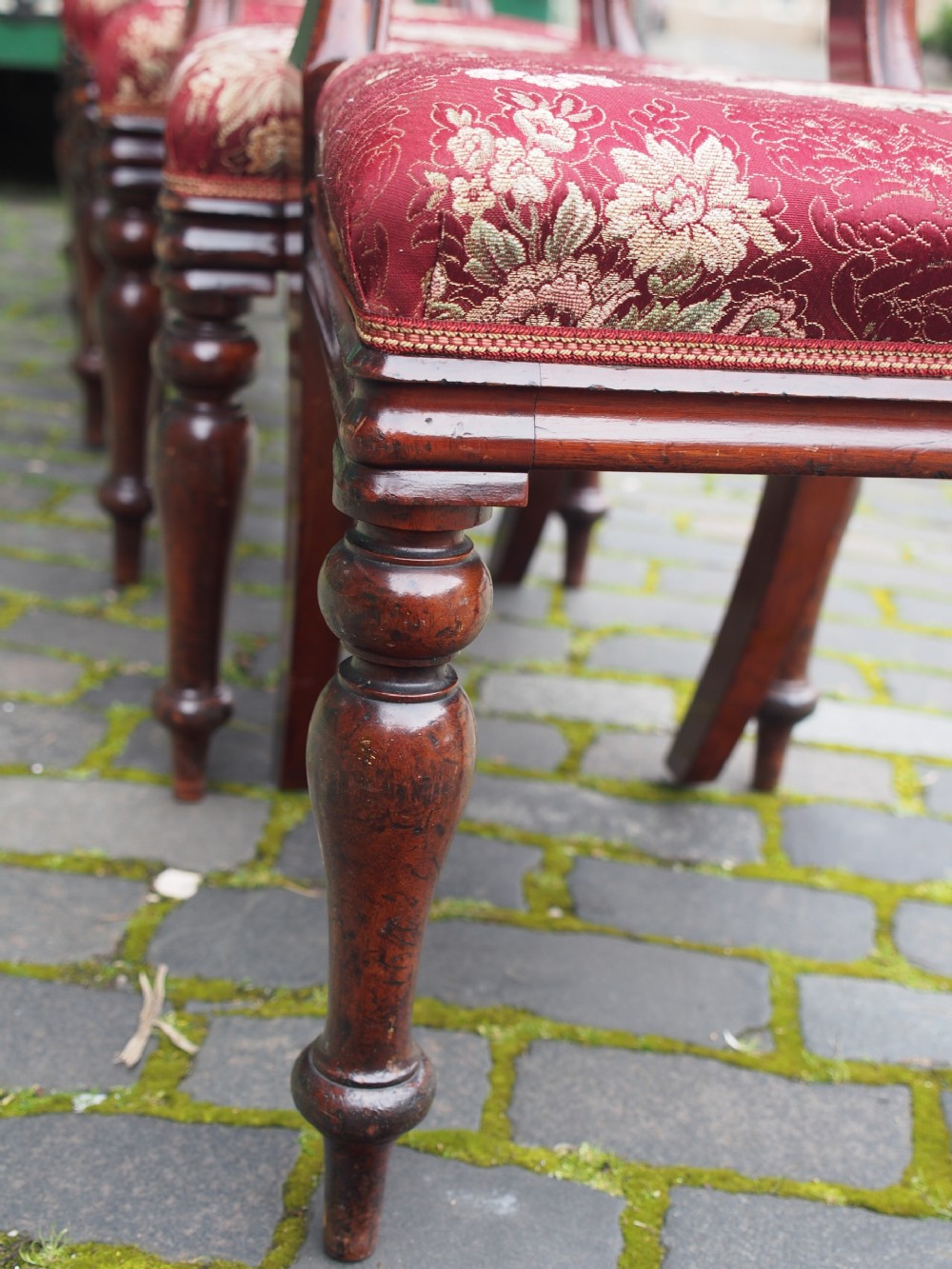 A set of six Victorian mahogany balloon back dining chairs with red patterned upholstered seats and turned front legs. View VII