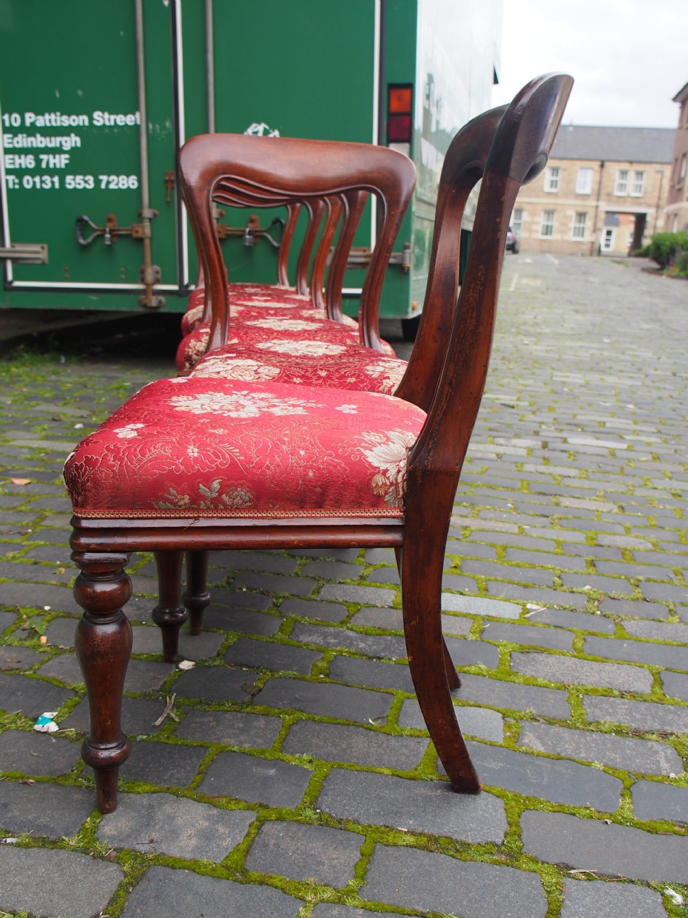A set of six Victorian mahogany balloon back dining chairs with red patterned upholstered seats and turned front legs. View IX