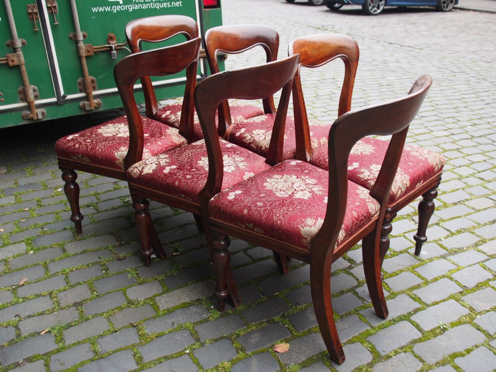 A set of six Victorian mahogany balloon back dining chairs with red patterned upholstered seats and turned front legs. View X