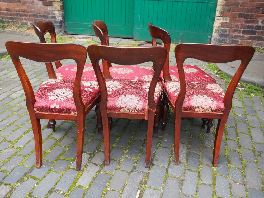 A set of six Victorian mahogany balloon back dining chairs with red patterned upholstered seats and turned front legs. View XI