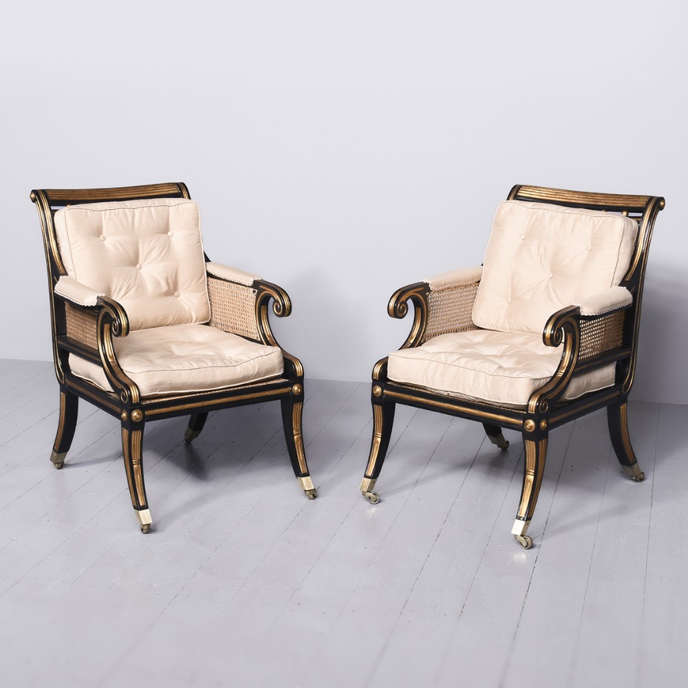 Rare Pair of Large Regency Cane Upholstered Gilt and Ebonized Bergère Chairs