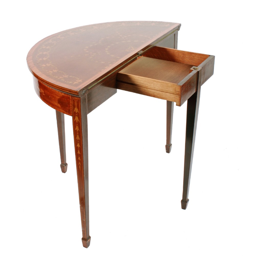 A semi-circular mahogany card table featuring floral marquetry inlay on the top and apron, supported by four square tapered legs. View II