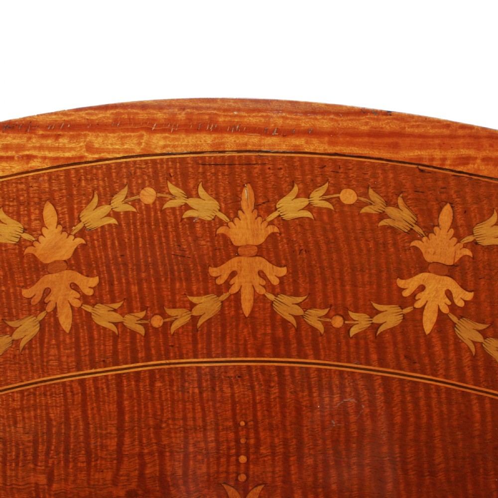 A semi-circular mahogany card table featuring floral marquetry inlay on the top and apron, supported by four square tapered legs. View VIII