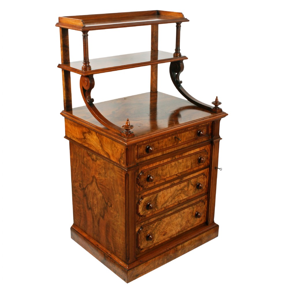 A mid-Victorian burr walnut writing desk featuring an upper superstructure with two open shelves supported by turned columns and scrolled side brackets above four drawers with turned wooden knobs.