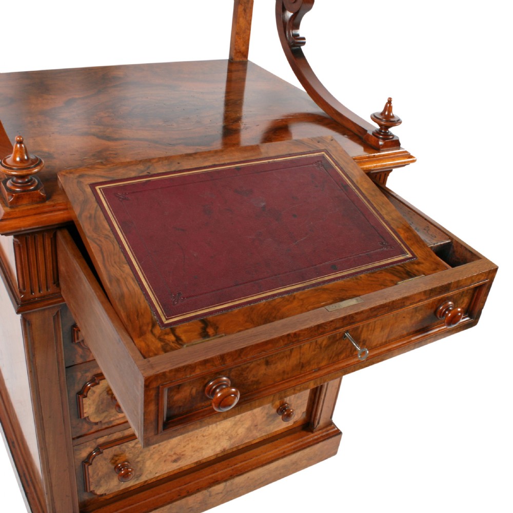 A mid-Victorian burr walnut writing desk featuring an upper superstructure with two open shelves supported by turned columns and scrolled side brackets above four drawers with turned wooden knobs. View III