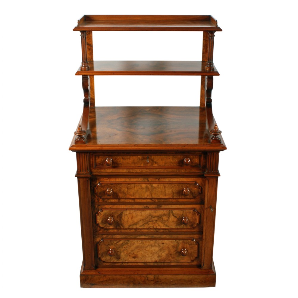A mid-Victorian burr walnut writing desk featuring an upper superstructure with two open shelves supported by turned columns and scrolled side brackets above four drawers with turned wooden knobs. View IV