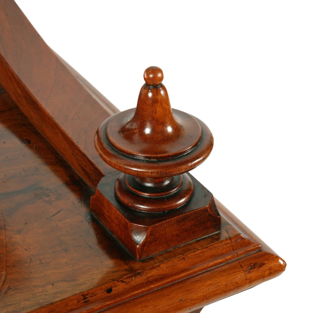 A mid-Victorian burr walnut writing desk featuring an upper superstructure with two open shelves supported by turned columns and scrolled side brackets above four drawers with turned wooden knobs. View VIII