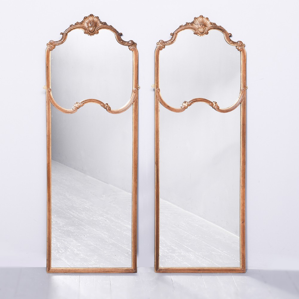 Decorative pair of elegant French carved and gilded walnut wall mirrors