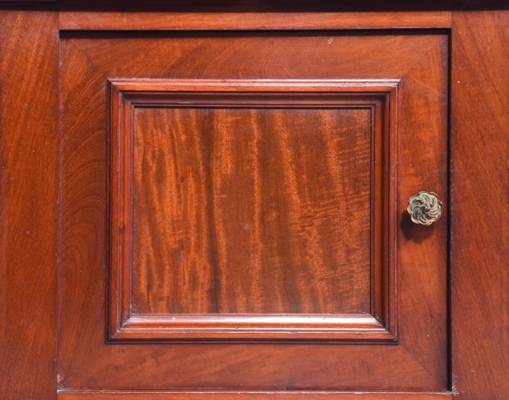 A pair of tall Victorian mahogany lamp stands featuring top drawers, open middle tiers supported by turned columns, and single-door lower cupboards. View VIII