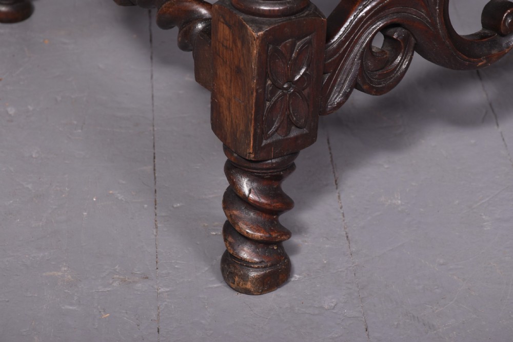 A pair of high-backed carved oak throne chairs featuring blue velvet upholstered panels and seat cushions, barley twist uprights, and carved shell crestings. View V