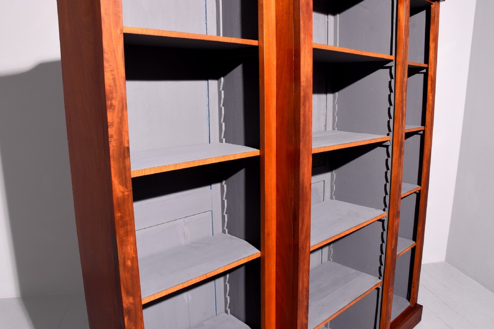 An early Victorian mahogany breakfront open bookcase featuring three sections with adjustable shelving and a grey painted interior. View II