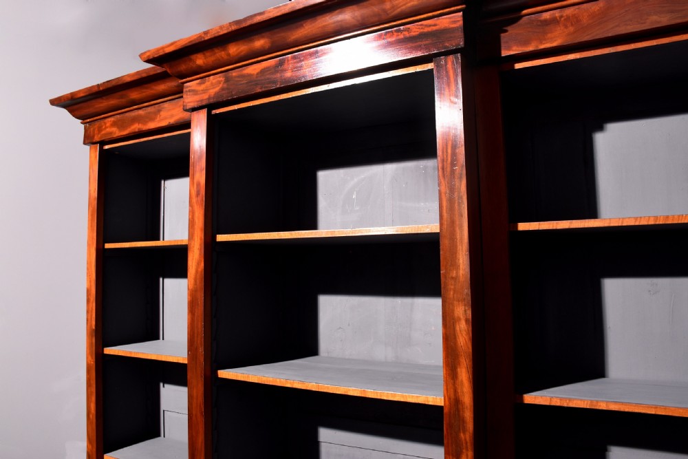 An early Victorian mahogany breakfront open bookcase featuring three sections with adjustable shelving and a grey painted interior. View IV