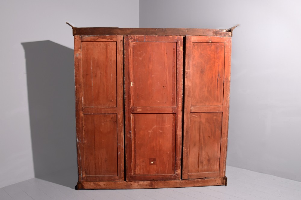 An early Victorian mahogany breakfront open bookcase featuring three sections with adjustable shelving and a grey painted interior. View V