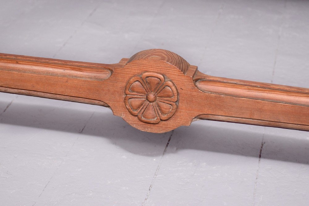 A narrow pitch pine console table featuring a rectangular top, turned twin-column end supports, and a central stretcher with a carved rosette motif. View II
