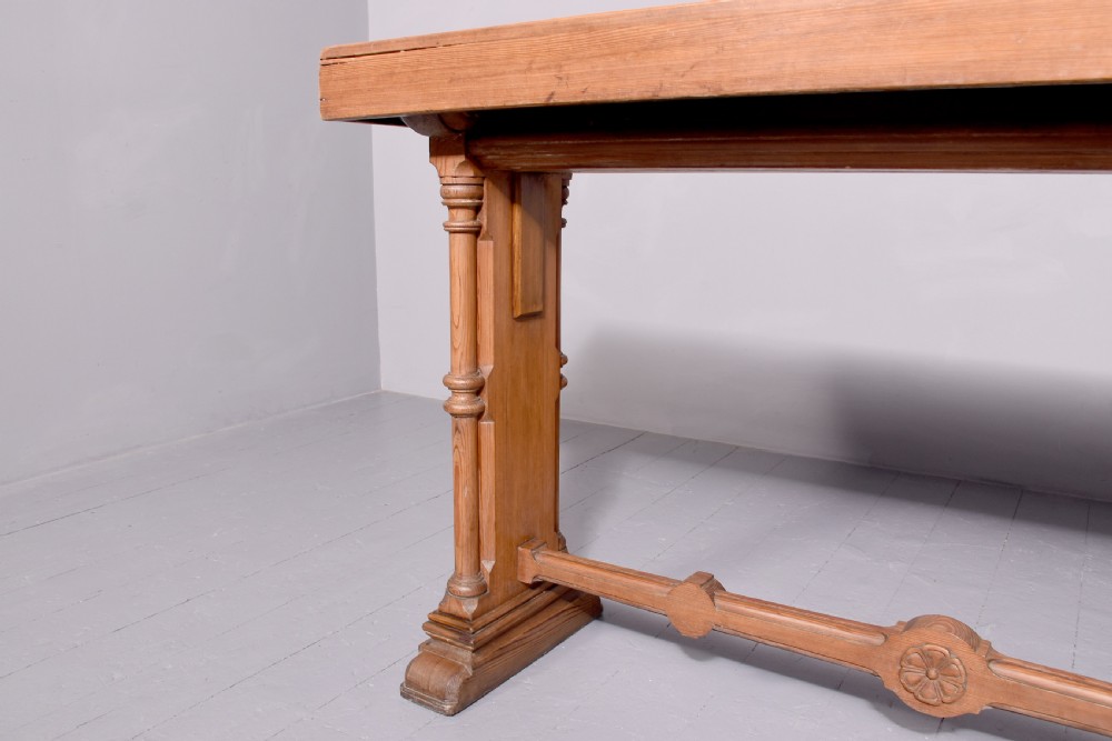 A narrow pitch pine console table featuring a rectangular top, turned twin-column end supports, and a central stretcher with a carved rosette motif. View III