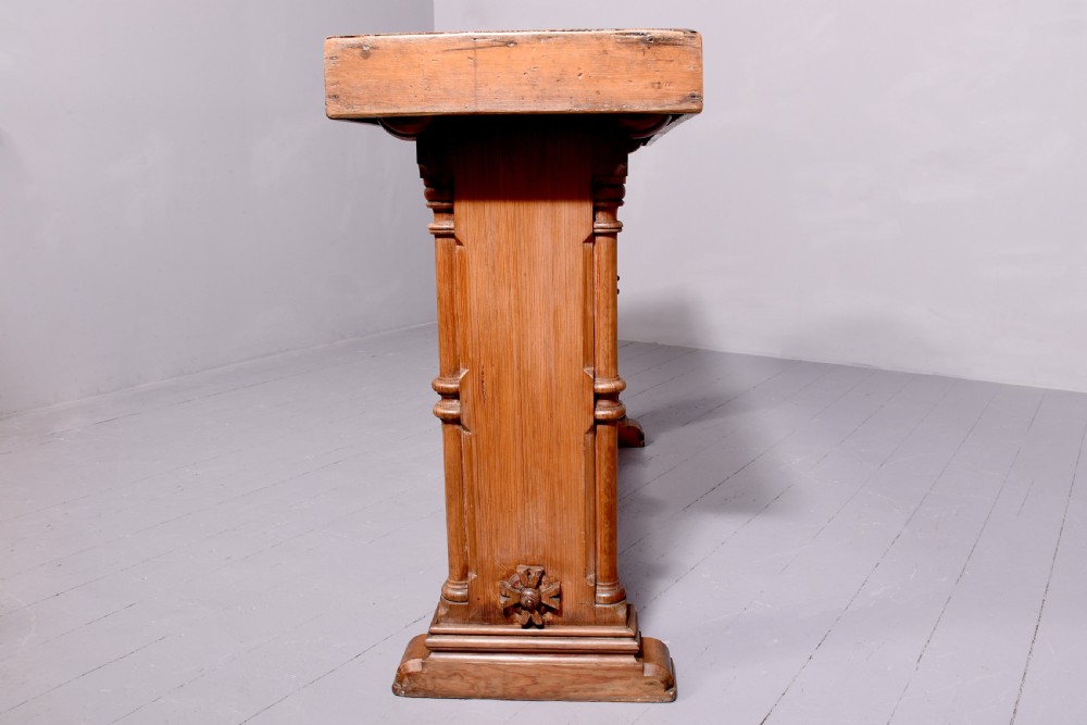 A narrow pitch pine console table featuring a rectangular top, turned twin-column end supports, and a central stretcher with a carved rosette motif. View IV