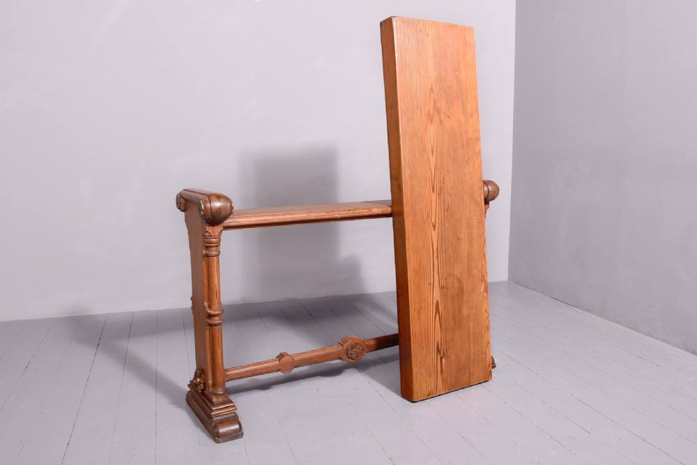 A narrow pitch pine console table featuring a rectangular top, turned twin-column end supports, and a central stretcher with a carved rosette motif. View V