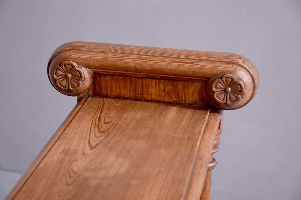 A narrow pitch pine console table featuring a rectangular top, turned twin-column end supports, and a central stretcher with a carved rosette motif. View VI