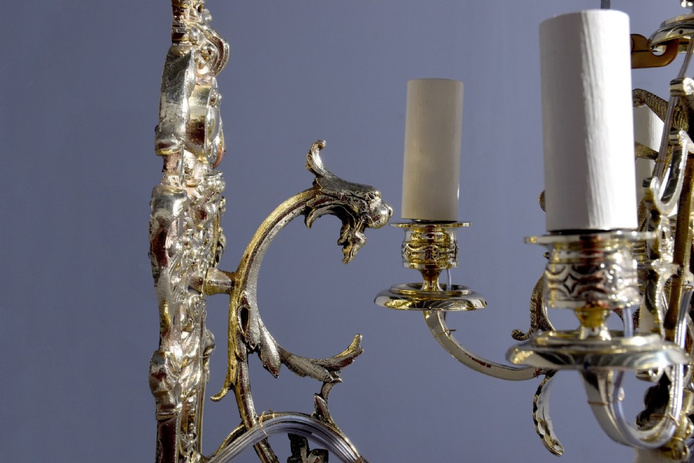 A pair of cast brass Rococo-style five-light wall sconces featuring scrollwork backplates and sweeping candle arms. View II