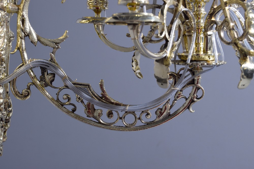 A pair of cast brass Rococo-style five-light wall sconces featuring scrollwork backplates and sweeping candle arms. View III