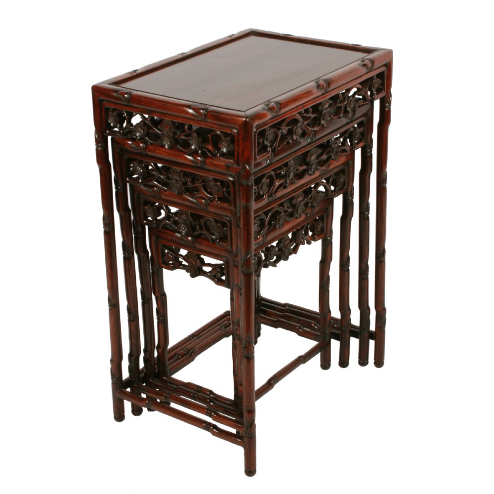 A set of four graduated dark brown Chinese hardwood nesting tables featuring faux-bamboo carved legs and pierced openwork aprons. View IV