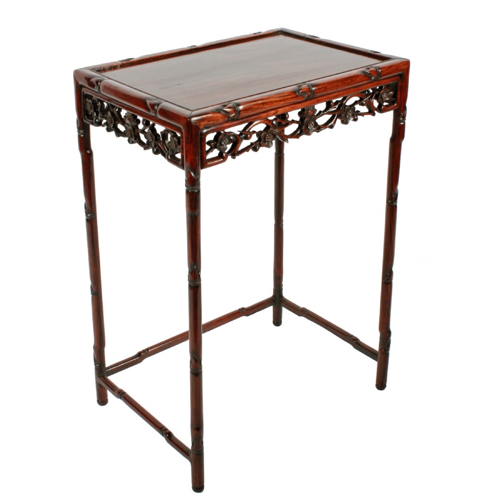 A set of four graduated dark brown Chinese hardwood nesting tables featuring faux-bamboo carved legs and pierced openwork aprons. View V