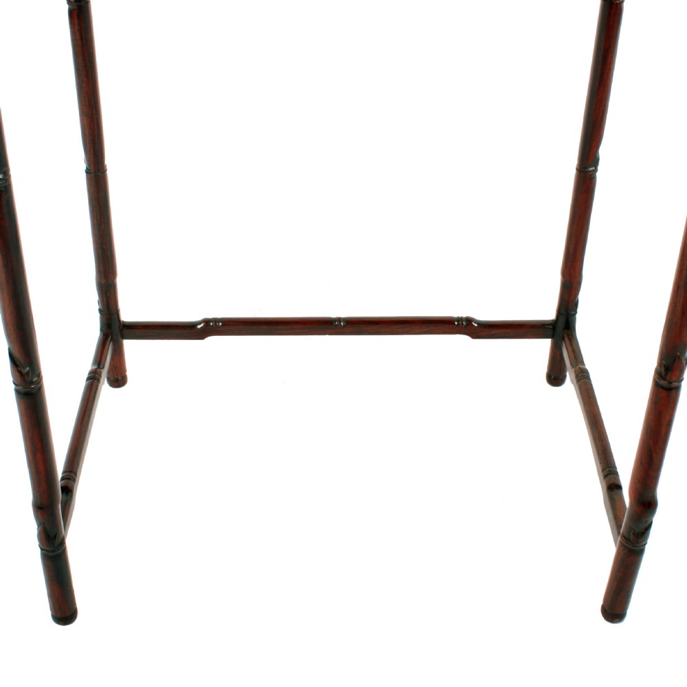 A set of four graduated dark brown Chinese hardwood nesting tables featuring faux-bamboo carved legs and pierced openwork aprons. View VI
