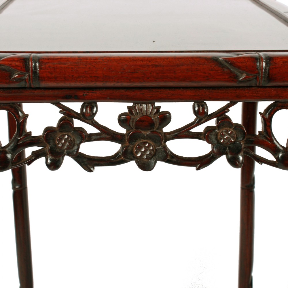 A set of four graduated dark brown Chinese hardwood nesting tables featuring faux-bamboo carved legs and pierced openwork aprons. View VII