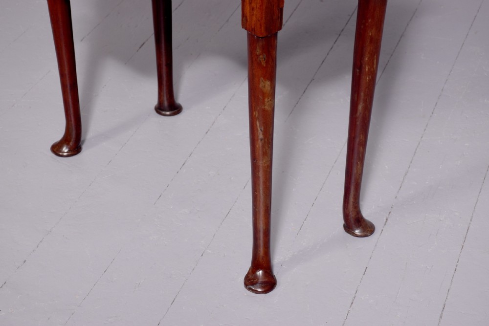 A George II mahogany fold-over games table featuring projecting rounded corners, a central drawer with brass drop handle, and slender legs ending in pad feet. View VI