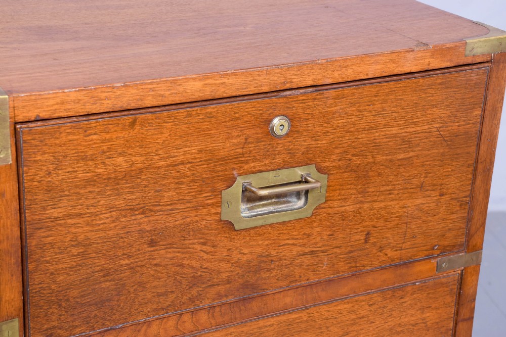 A Victorian mahogany two-part military campaign chest with flush brass handles, protective brass corner brackets, and turned legs. View III