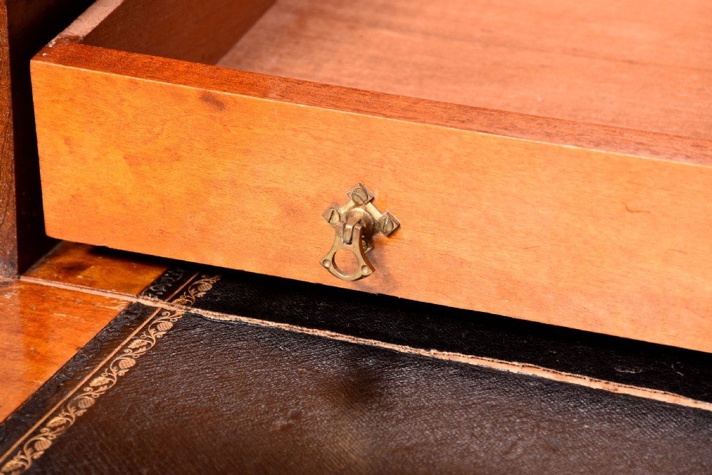 A Victorian mahogany two-part military campaign chest with flush brass handles, protective brass corner brackets, and turned legs. View XI
