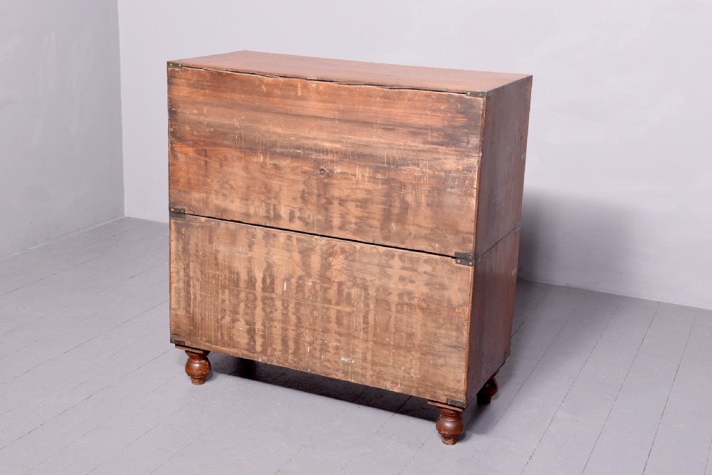 A Victorian mahogany two-part military campaign chest with flush brass handles, protective brass corner brackets, and turned legs. View XII