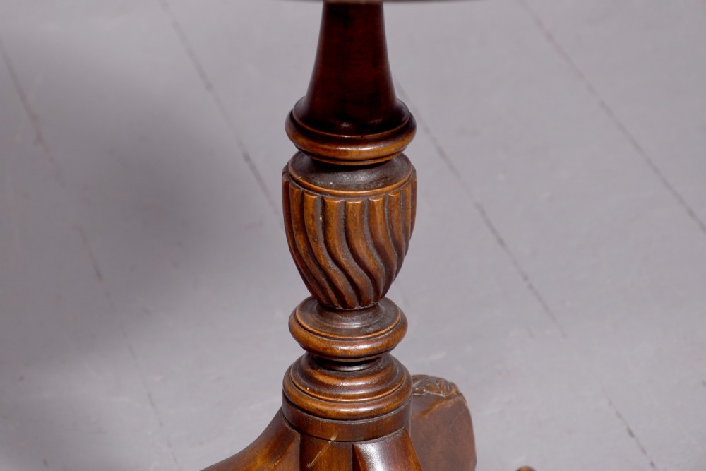 A round mahogany occasional table featuring a raised spindle gallery top, turned central pedestal stem, and cabriole tripod legs ending in claw and ball feet. View III