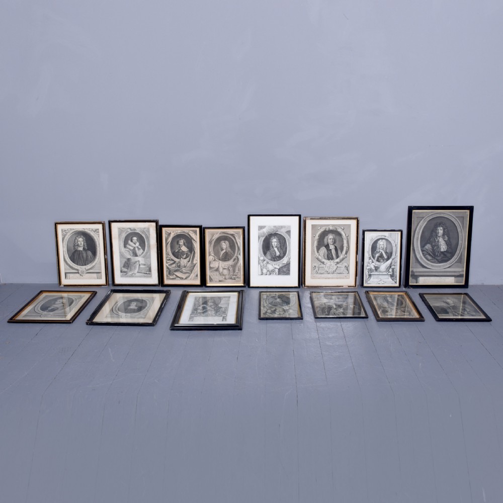 A collection of fifteen framed antique monochrome portrait engravings featuring oval borders and historical figures.