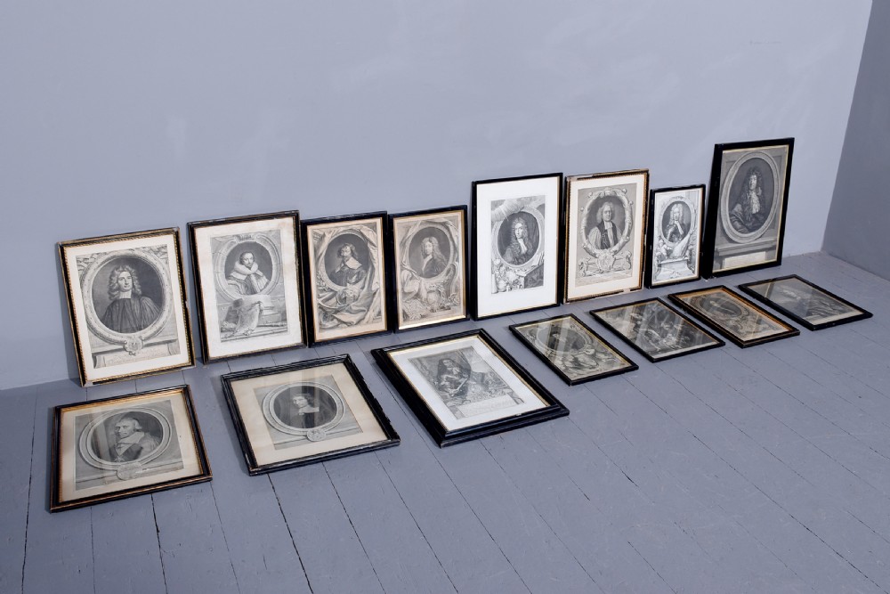 A collection of fifteen framed antique monochrome portrait engravings featuring oval borders and historical figures. View IX