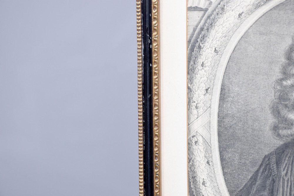 A collection of fifteen framed antique monochrome portrait engravings featuring oval borders and historical figures. View XV