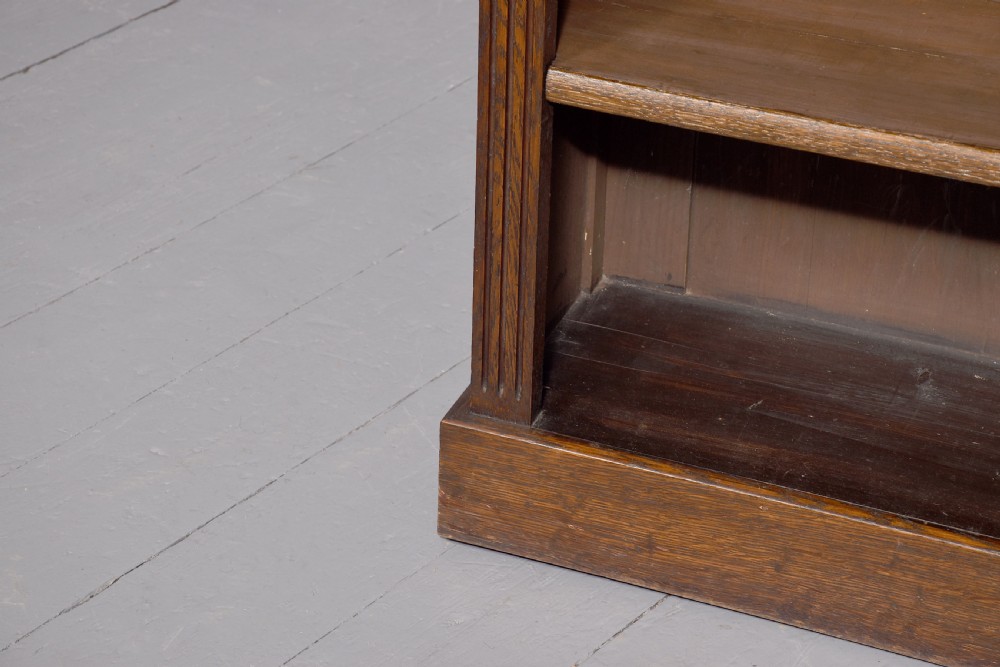 A large dark oak breakfront open bookcase filled with rows of leather-bound books. View VI